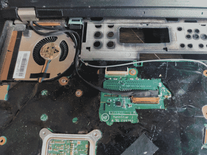 Image of the mod chip installed on the motherboard with a cable connected